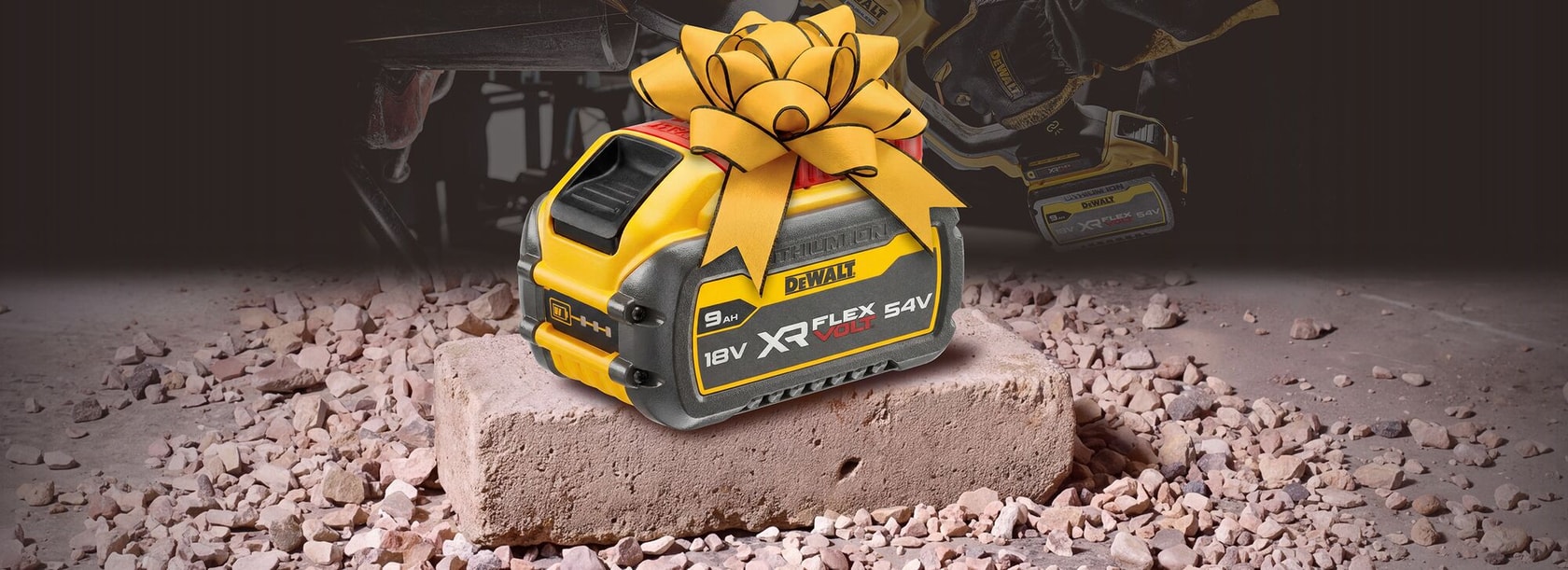 DEWALT XR FLEXVOLT battery with yellow bow on a brick, surrounded by rubble.
